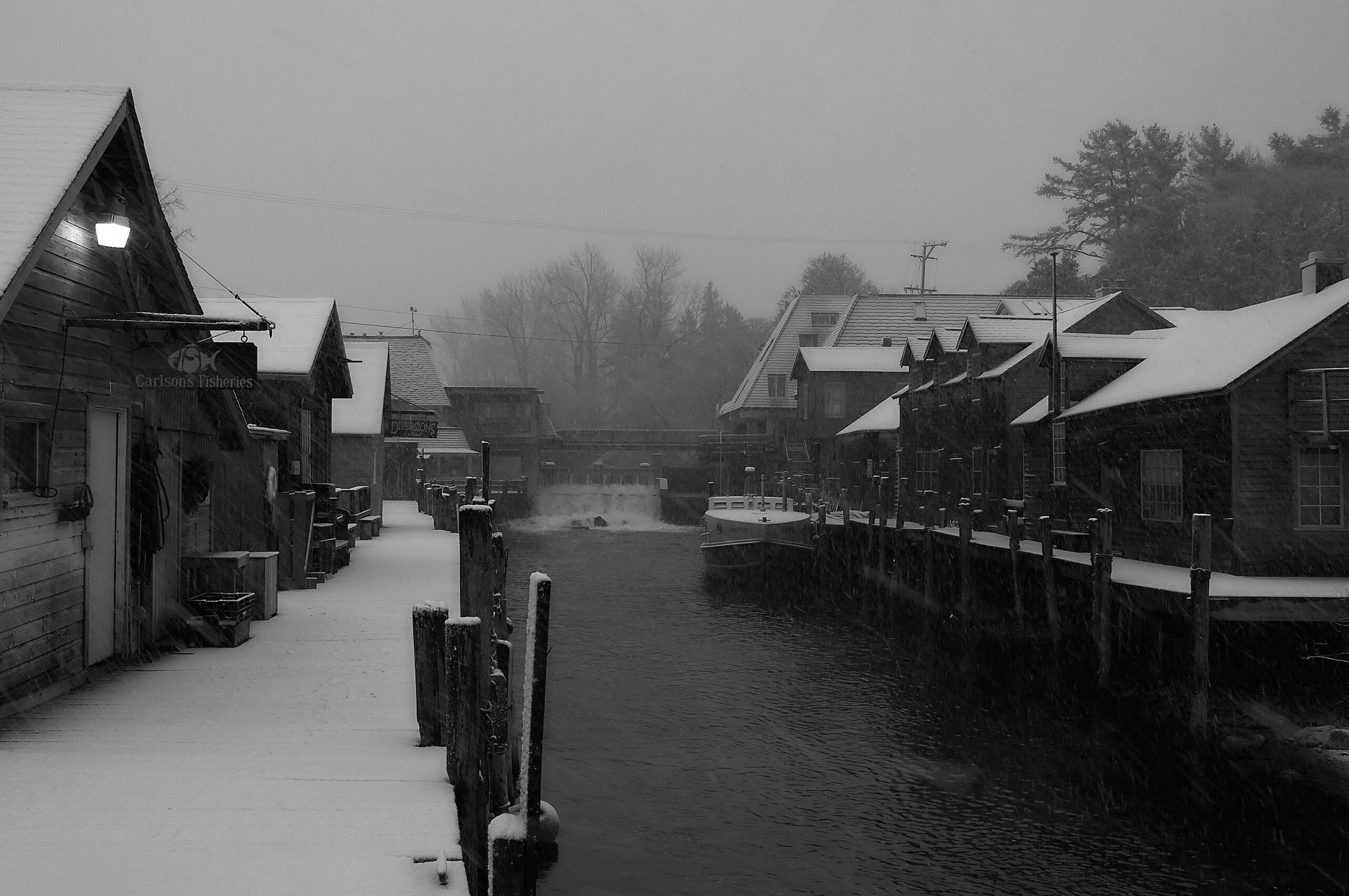fish town Leland in the winter looking eastward towards the cove restaurant the the carp river dam